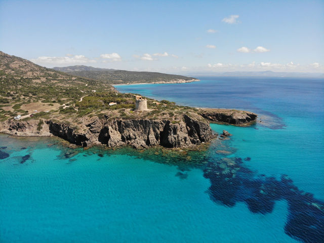 Stunning coastal view of Torre Cannai and crystal blue waters in Sardinia, Italy.