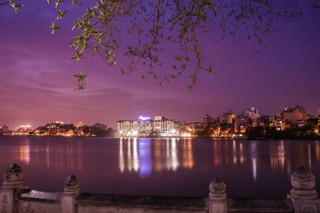 Nightscape with buildings reflected in the lake.