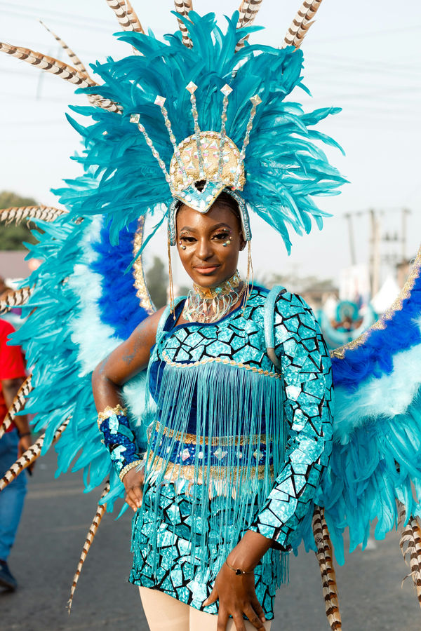 Turquoise plumes and a mirrored bodice, waiting for the parade to move