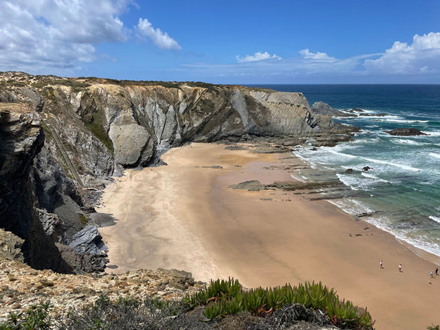 Beautiful view of Carvalhal Beach in Alentejo with cliffs and Atlantic Ocean waves.