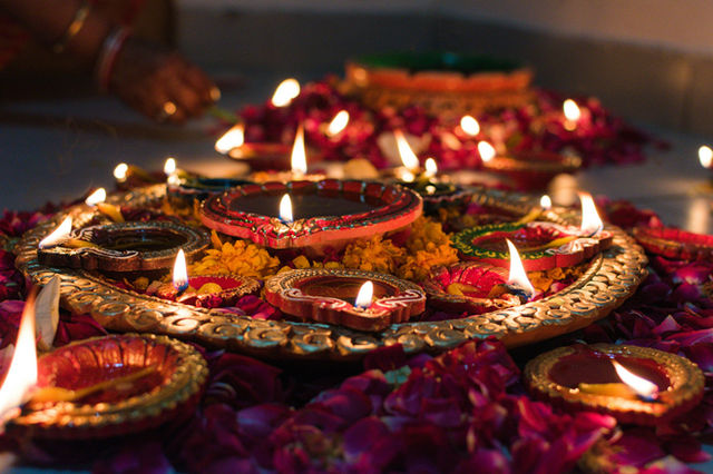 Oil lamps arranged on a decorated tray for Diwali