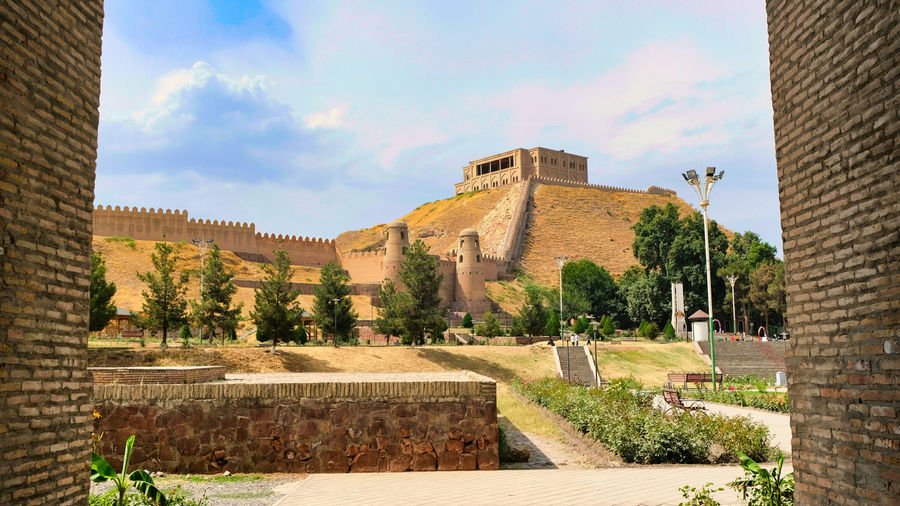 a view of a castle through two brick walls