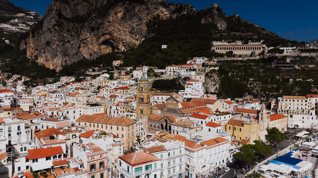 Stunning aerial view of Amalfi, Italy showcasing terracotta rooftops and Mediterranean architecture.
