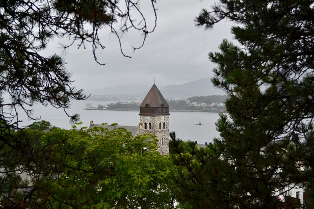A church spire view in the backdrop of Ålesund waterways. Circa 2013.