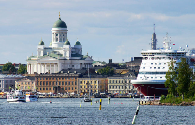 Helsinki, Finland harbor with the cathedral on the left and a large ferry/cruise ship looming large on the right.