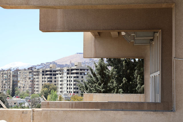 Elevated architectural view showcasing Damascus cityscape with buildings and greenery. Captures unique urban perspective.