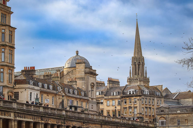 Explore the stunning historic architecture and skyline of Bath, England featuring iconic church spires.