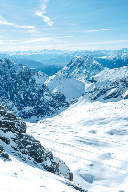 Snow covered mountains under a clear blue sky