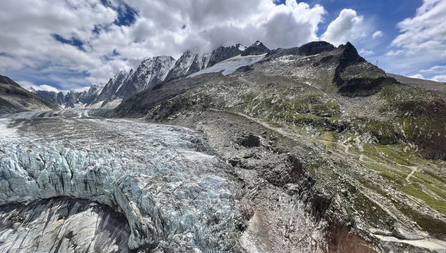Blue glacier ice tumbling toward the valley below the Mont Blanc massif, Chamonix