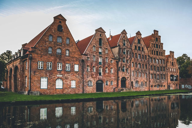 Picturesque view of historic Lübeck Salzspeicher reflected in the water.