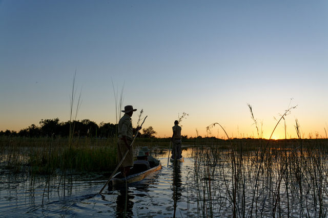 a group of people fishing in a river