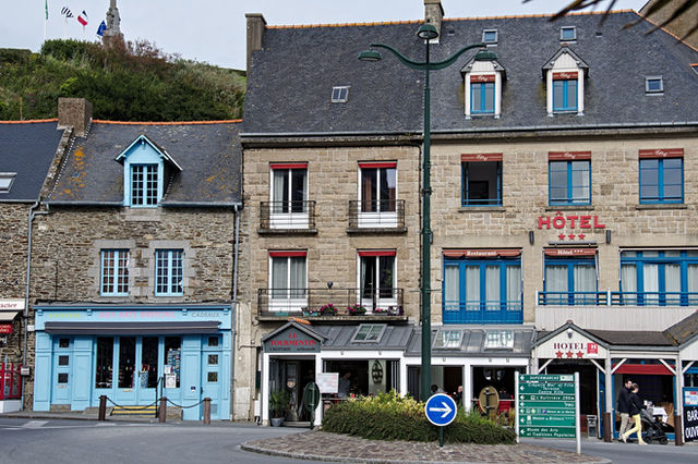 Street view of a traditional hotel facade in Brittany, showcasing classic French architecture.