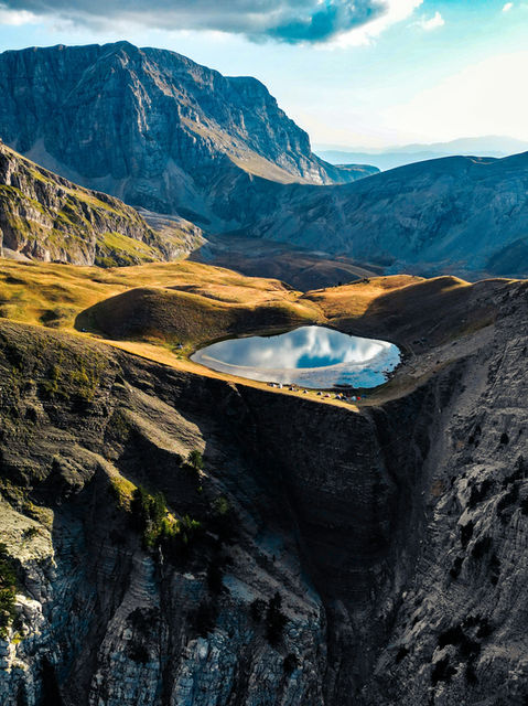 A serene alpine lake nestled among rugged mountains
