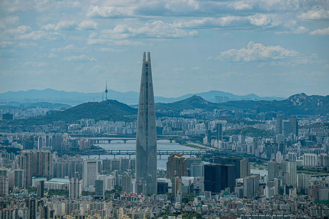 a very tall tower towering over a city