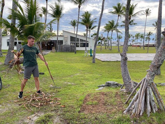 210816-N-CE120-1003 KWAJALEIN ATOLL, Marshall Islands (Aug. 16, 2021) Ensign Trygve McCrea, assigned to Naval Mobile Construction Battalion (NMCB) 5, cleans and landscapes a local