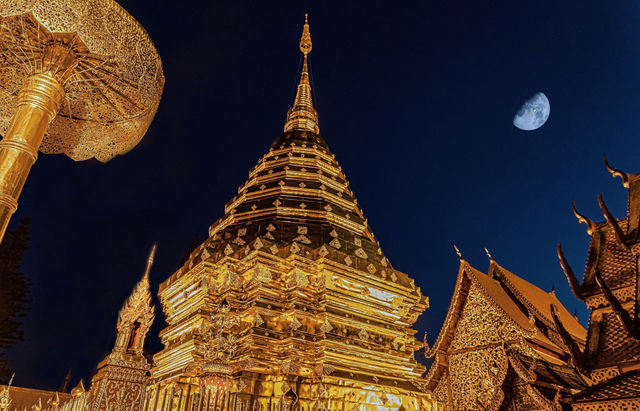 Majestic Wat Phra That Doi Suthep shines under the night sky in Chiang Mai, Thailand.