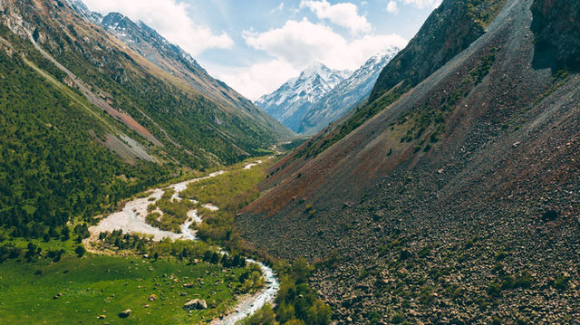 Stunning view of Chunkurchak Valley with river and snow-capped mountains in Chuy Province, Kyrgyzstan.