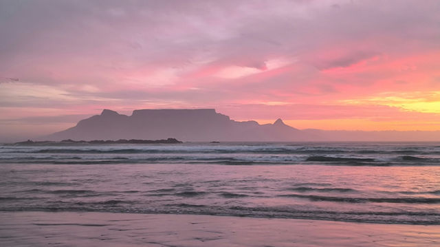 View of Table Mountain from Big Bay, Bloubergstrand at sunset.
