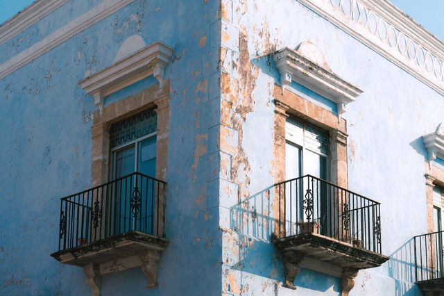 Restored colonial building facade with blue paint in San Francisco de Campeche, Mexico.