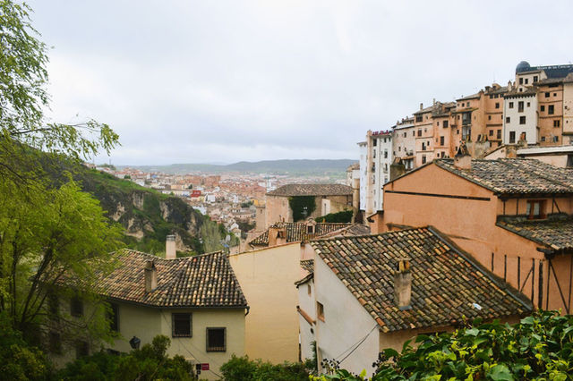 Charming view of historic Cuenca with traditional rooftops and scenic landscape, perfect for travel enthusiasts.