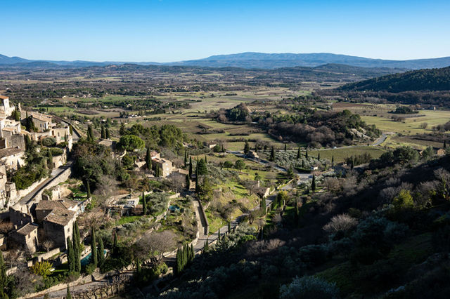 Aerial view of Gordes, a beautiful village in Provence, France with lush landscapes and historic architecture.