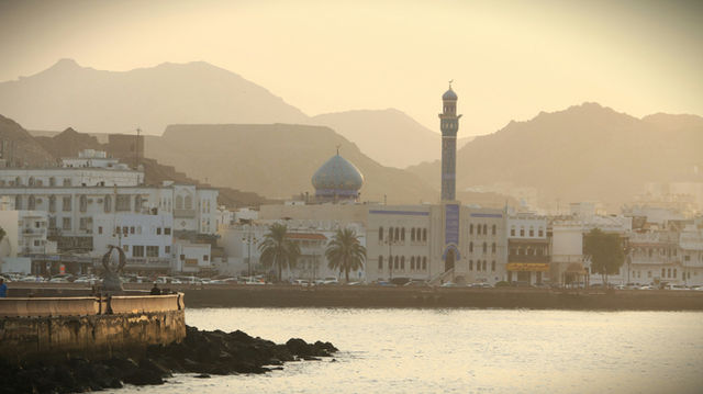 A body of water with a city in the background