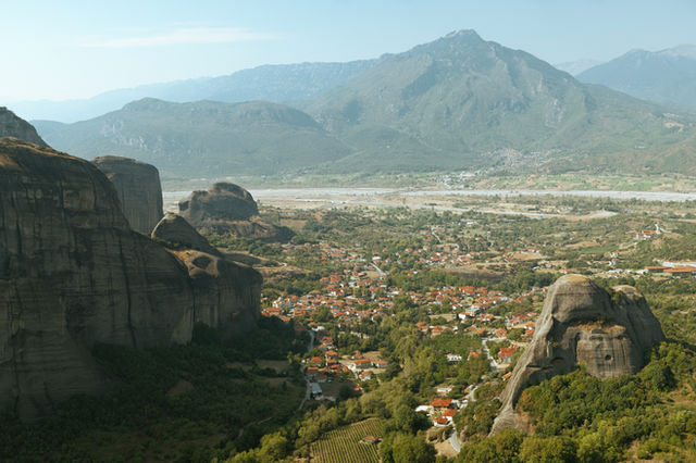A scenic view of a valley with mountains in the background