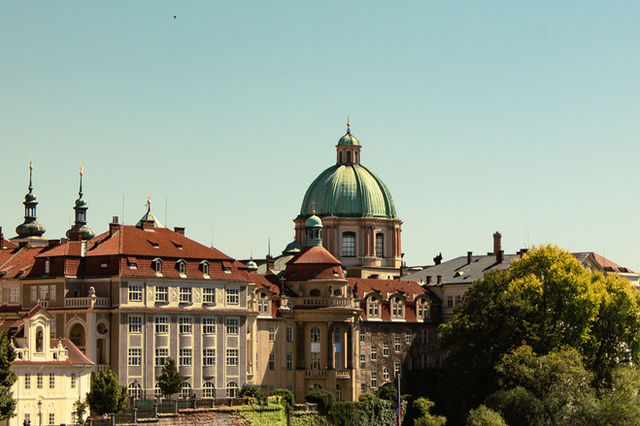 Cityscape featuring historic architecture and domed rooftops in Prague.