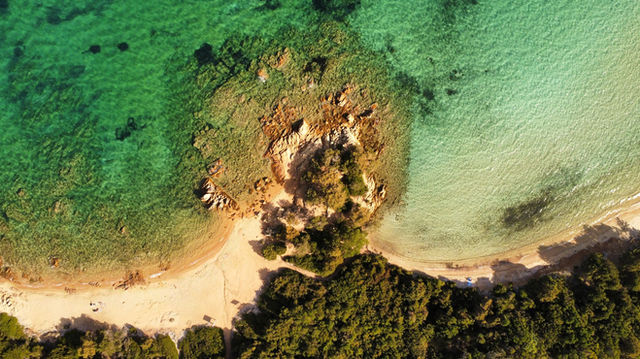 Stunning aerial view of Sardinia coastline with sandy beaches and turquoise waters.