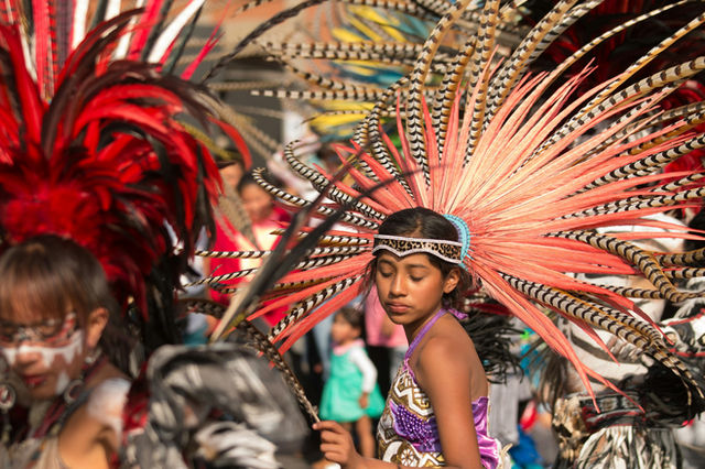 A gold crown over purple — a Mexica dancer in Mexico City