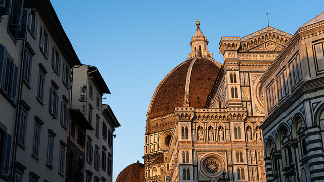 The iconic dome of Florence Cathedral basking in the warm light of sunset, showcasing its architectural majesty.