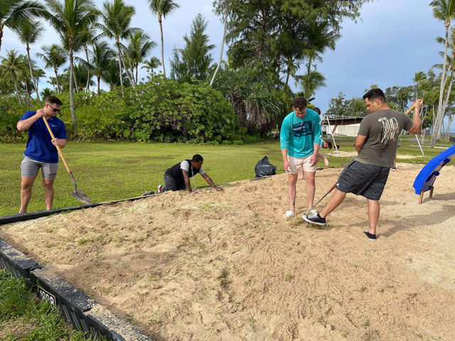 210816-N-CE120-1001 KWAJALEIN ATOLL, Marshall Islands (Aug. 16, 2021) U.S. Navy Seabees assigned to Naval Mobile Construction Battalion (NMCB) 5 clean and landscape a local playgro
