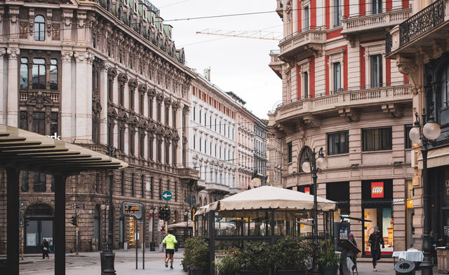 Charming street scene capturing the ornate architectural facades in Milan, Italy.