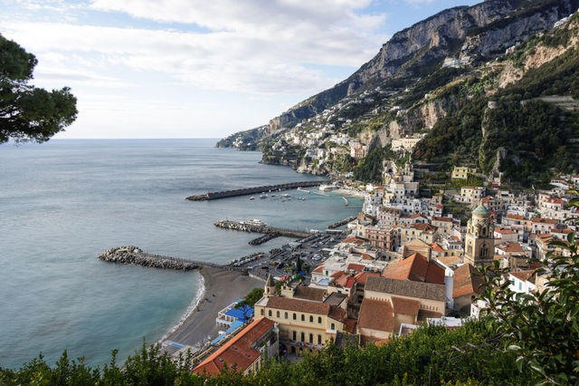 Breathtaking view of Amalfi's charming coastline with colorful buildings and Mediterranean Sea.