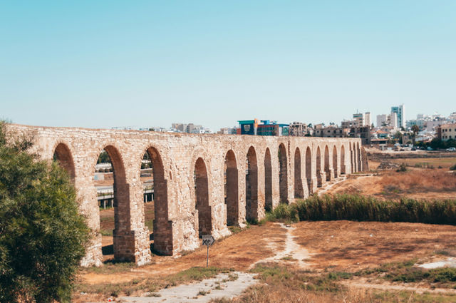 brown concrete bridge under blue sky during daytime
