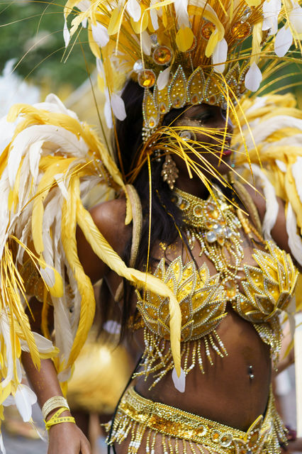 Yellow and white plumes, arms lifted — the Paris tropical carnival