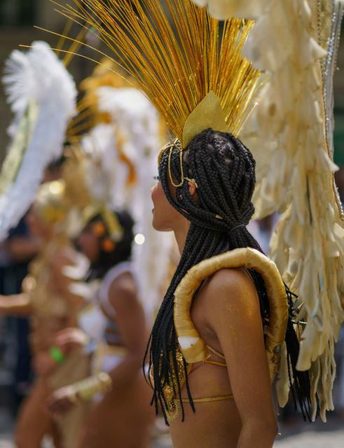 A feathered crown above a jewelled bodice — the Paris tropical carnival