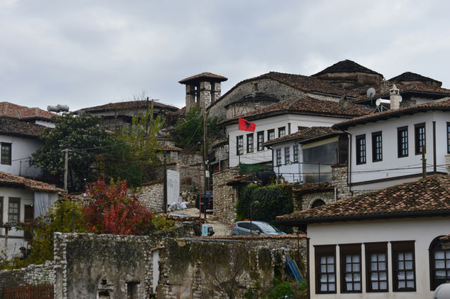 White houses with tiled roofs on a hill.