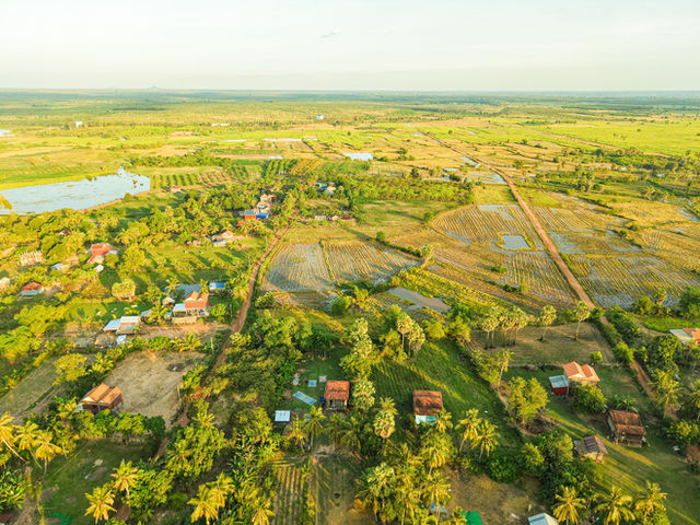 A stunning aerial view of Cambodia's lush countryside landscapes, featuring rice paddies and farmland.