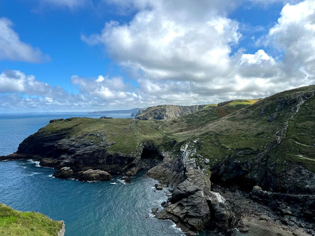 Stunning aerial view of rugged cliffs and coastline in Cornwall, England on a bright summer day.