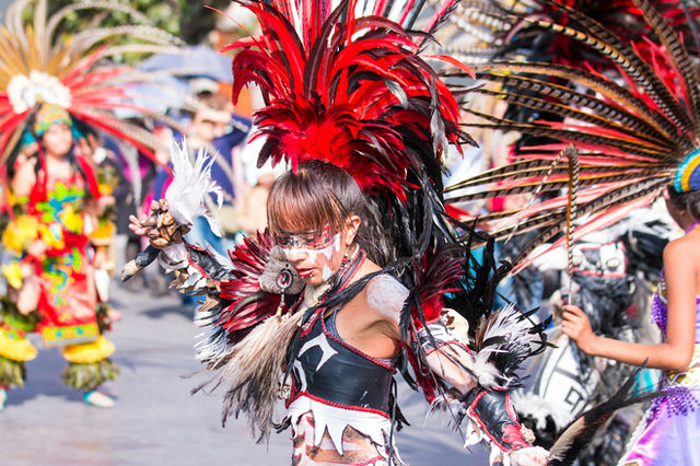 Red and white at the Zócalo — a Mexica dancer in Mexico City