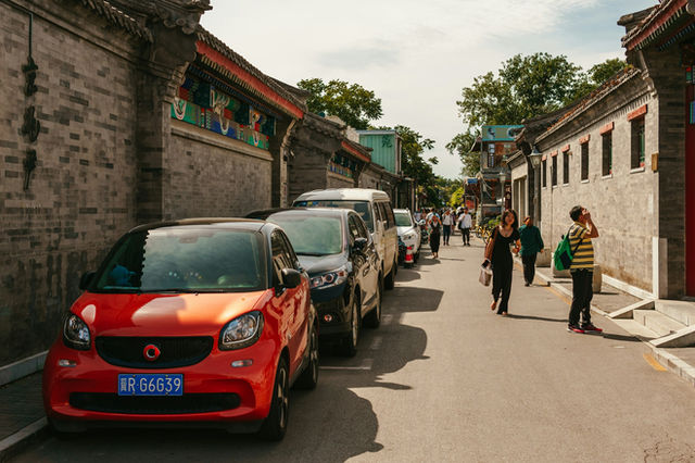 A red car parked on the side of a road