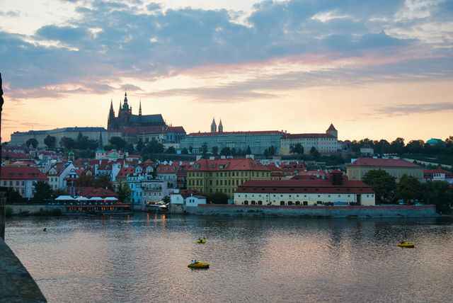 Cityscape with castle and river at dusk