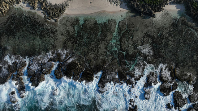 a bird's eye view of a beach and ocean