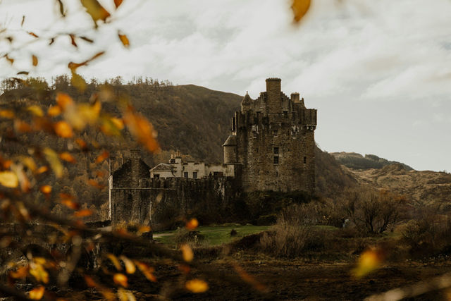 Ancient castle on a hill with autumn foliage