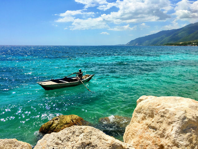 A boat moves through Wahoo Bay in Haiti.