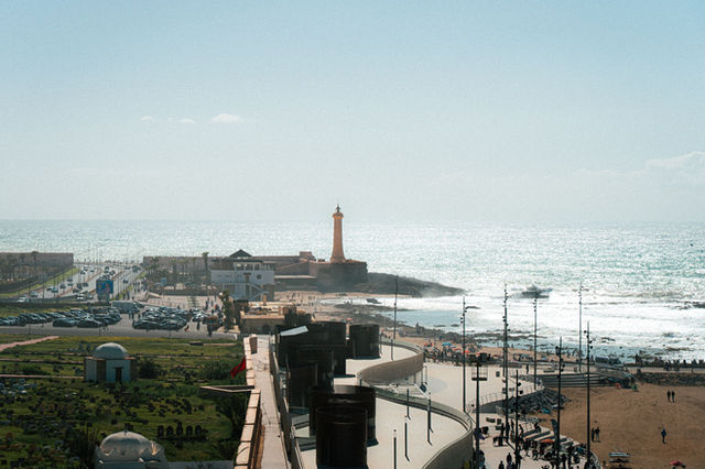 A stunning aerial view of Casablanca's lighthouse and coastline with the Atlantic Ocean in the background.