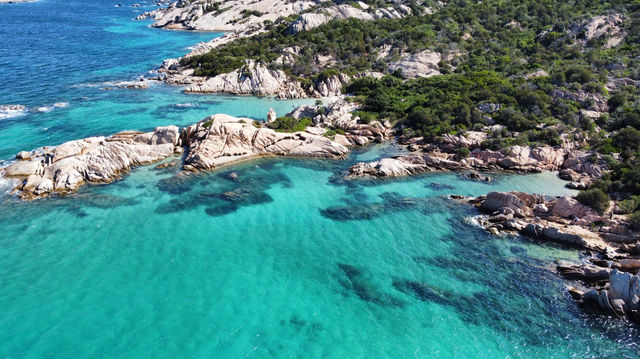 A stunning aerial view of San Teodoro, Sardinia showcasing rocky shores and vibrant turquoise waters.