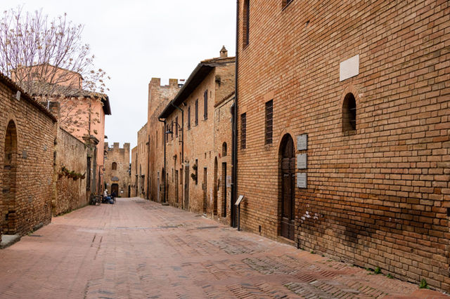 Explore the historic brick-lined streets of Certaldo in Tuscany, showcasing medieval architecture.