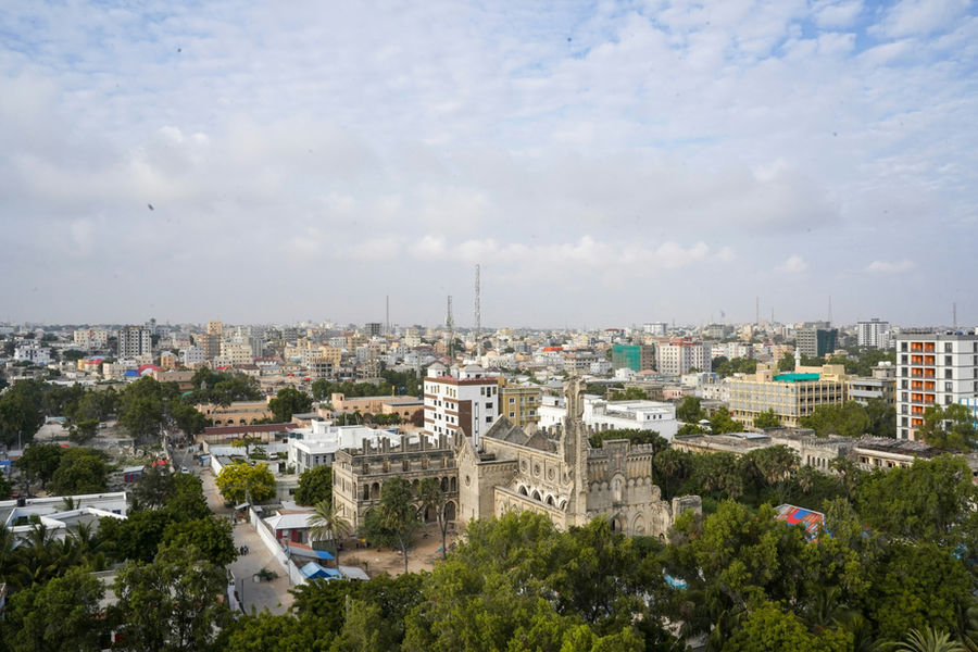 Cityscape with historic building and lush trees